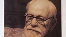 Schreibtisch-Details und ein Foto von Sigmund Freud | Bild: picture-alliance/dpa