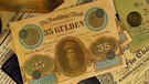 Banknoten und Münzen um 1870 | Bild: picture-alliance/dpa