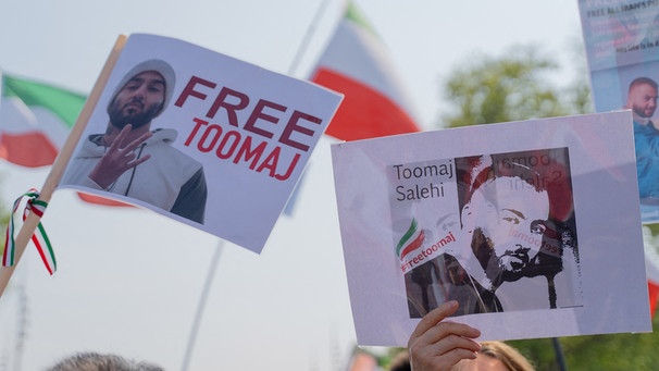Protestierende halten Fotos des iranischen Rappers Toomaj in die Höhe | Bild: picture alliance / abaca | Serie Claire/BePress/ABACA
