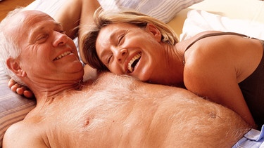 Älteres Paar - Mann und Frau, lachend im Bett, das sich liebt. | Bild: picture-alliance/dpa