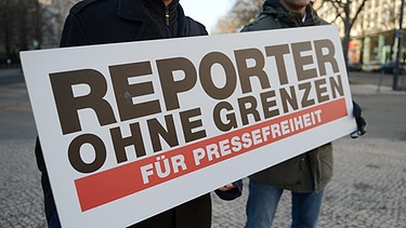 Zwei Männer tragen ein Schild auf dem steht: Reporter ohne Grenzen - für Pressefreiheit | Bild: picture-alliance/dpa