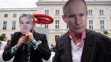 Demonstranten in Warschau protestieren - maskiertals Russlands Präsident Wladimir Putin und Ungarns Premierminister Viktor Orban - vor einer Attrappe einer Gaspipeline. | Bild: picture alliance / ZUMAPRESS.com | Aleksander Kalka